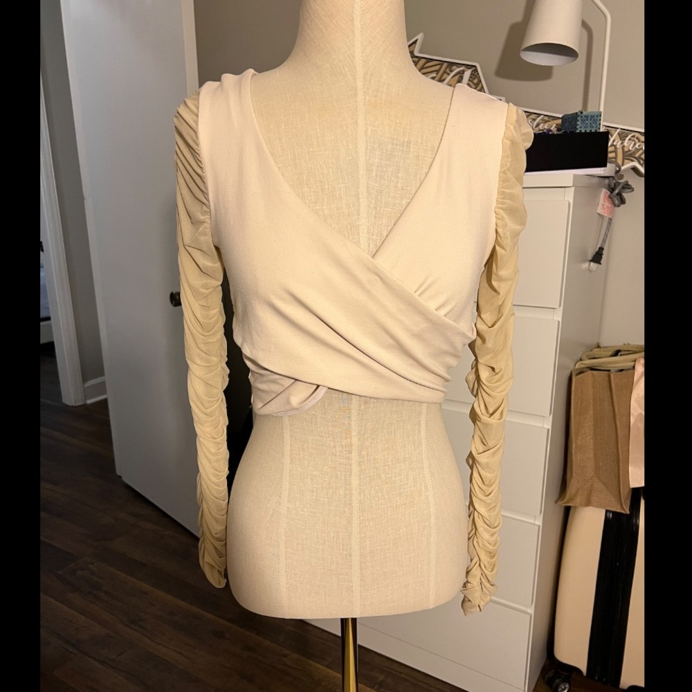 Cream bebe long sleeved crop top.